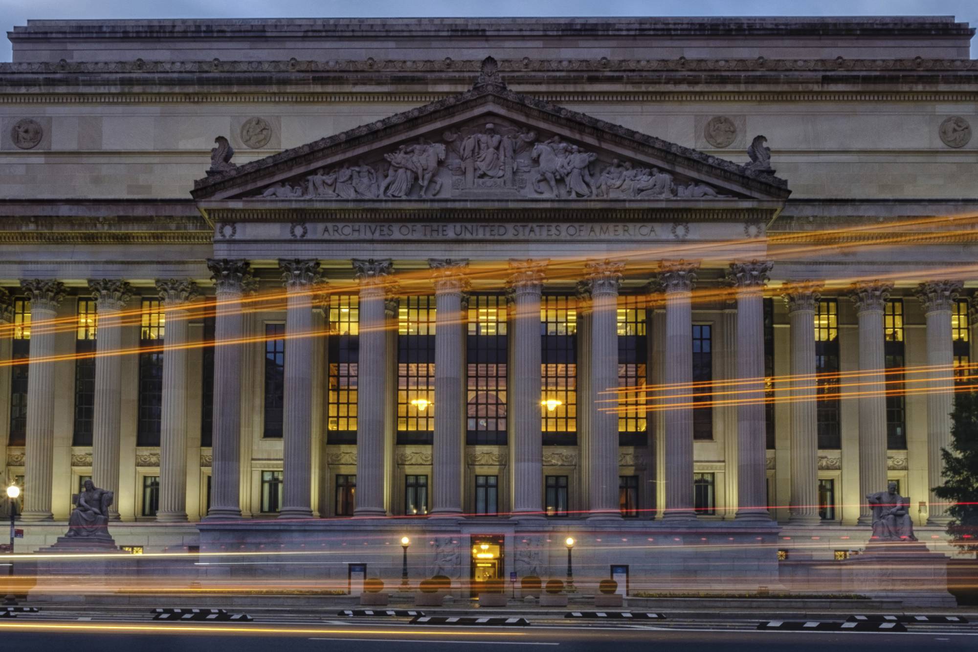 Traffic streaks past the U. S. National Archive headquarters building early in the morning, Tuesday, Oct. 24, 2017. President Donald Trump announced last week he intendeds to allow the National Archive to release additional classified documents on the assassination of President John F. Kenney. (AP Photos/J. David Ake)