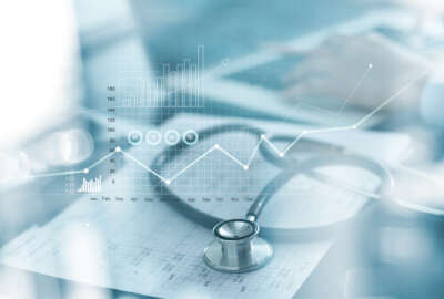 A health care data and AI concept showing charts and graphs overlaid across medical equipment.