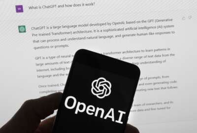 FILE - The OpenAI logo is seen on a mobile phone in front of a computer screen which displays output from ChatGPT, Tuesday, March 21, 2023, in Boston. Biden on Monday, Oct. 30, will sign a sweeping executive order to guide the development of artificial intelligence. The order will require industry to develop safety and security standards, introduce new consumer protections and give federal agencies an extensive to-do list to oversee the rapidly progressing technology. (AP Photo/Michael Dwyer, File)