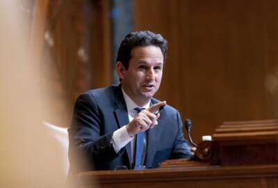 Sen. Brian Schatz, D-Hawaii, speaks as Commerce Secretary Gina Raimondo, testifies before a Senate Appropriations Subcommittee on Commerce, Justice, Science, and Related Agencies hearing on Capitol Hill in Washington, Tuesday, Feb. 1, 2022, to examine expanding broadband access, focusing on the Department of Commerce broadband programs in the Infrastructure Investment and Jobs Act. (AP Photo/Andrew Harnik, Pool)